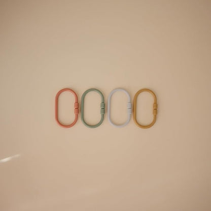 mushie Baby Chain Link Rings Toy 12-Count | Multiuse Car Seat Stroller Connecting Toy (Periwinkle, Mustard, Green, Coral)